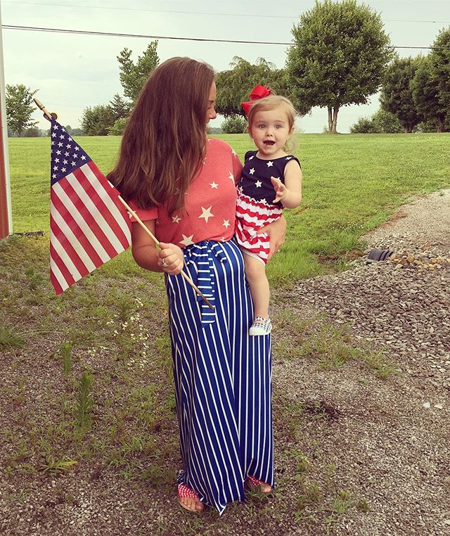 Bethany Henson wearing a blue and white maxi dress with a red shirt 