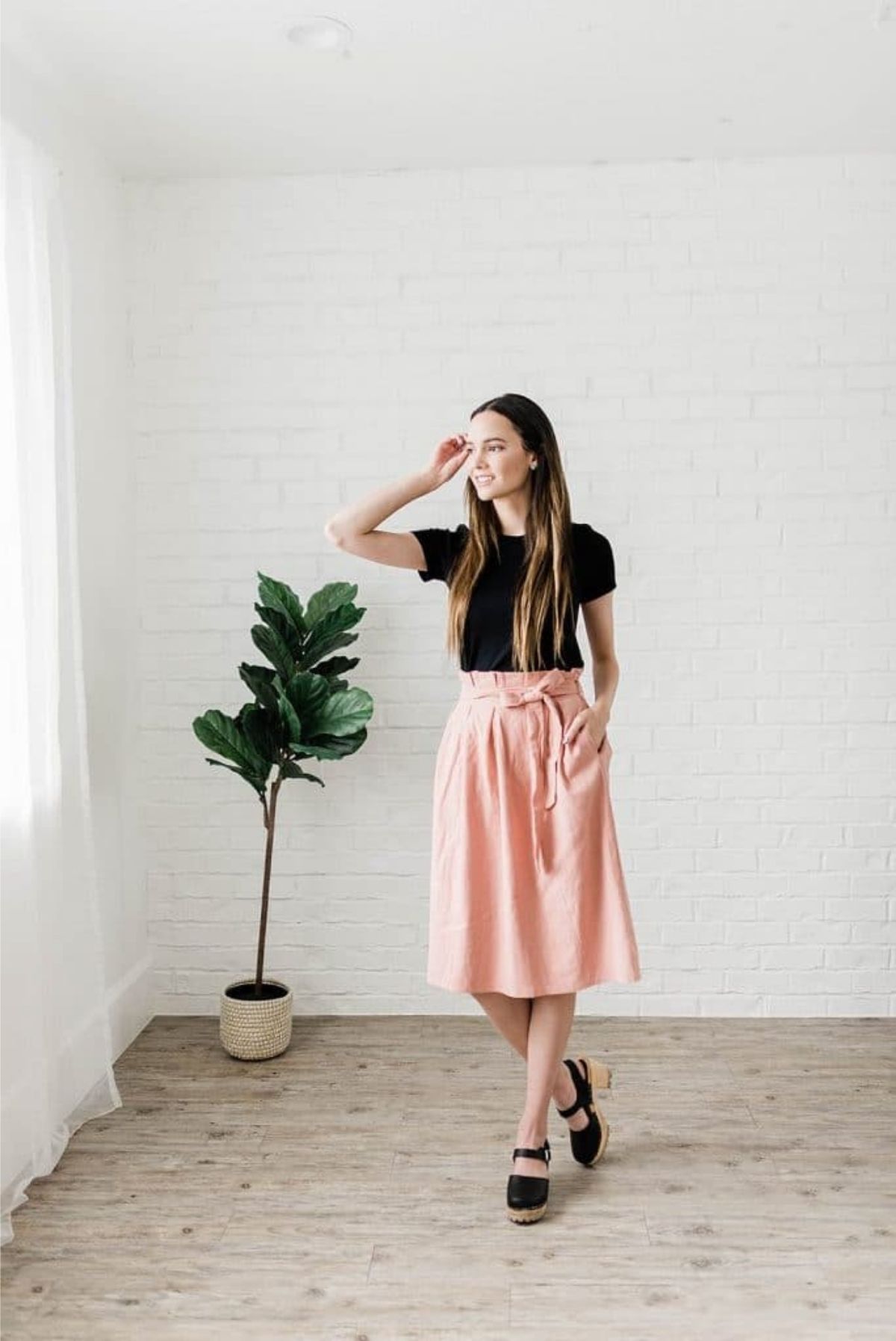 A high waisted skirt is an example of trendy modest clothing