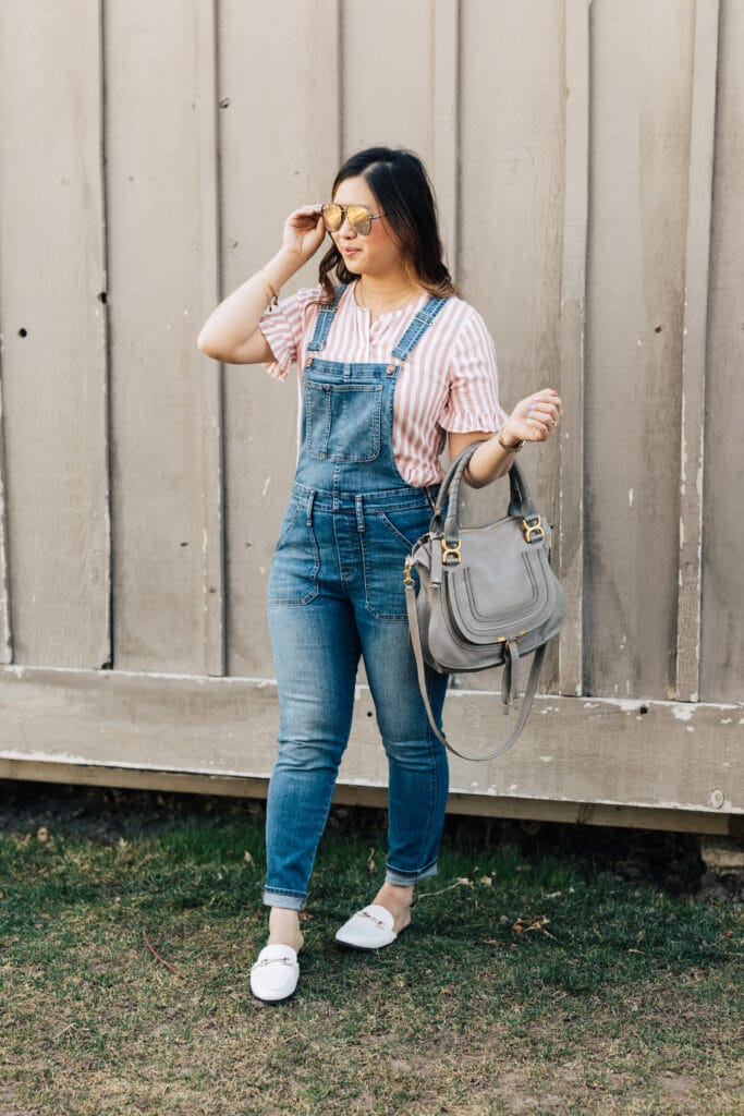 Sandy Chang from sandyalamode.com styles her denim overalls with white loafers and a pink striped ruffle top