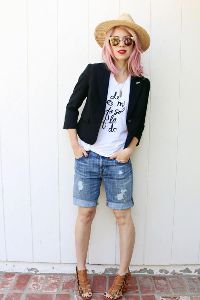 Outfit featuring distressed shorts, graphic tee, and blazer.