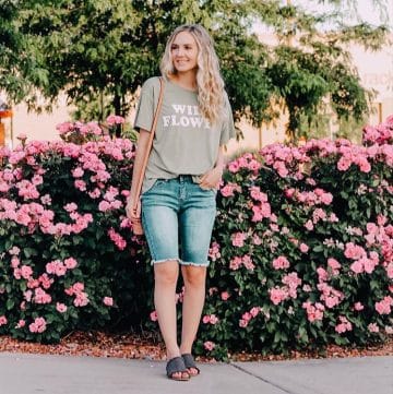 Jensyn put together an outfit with long denim shorts, sandals, and a fun t shirt.