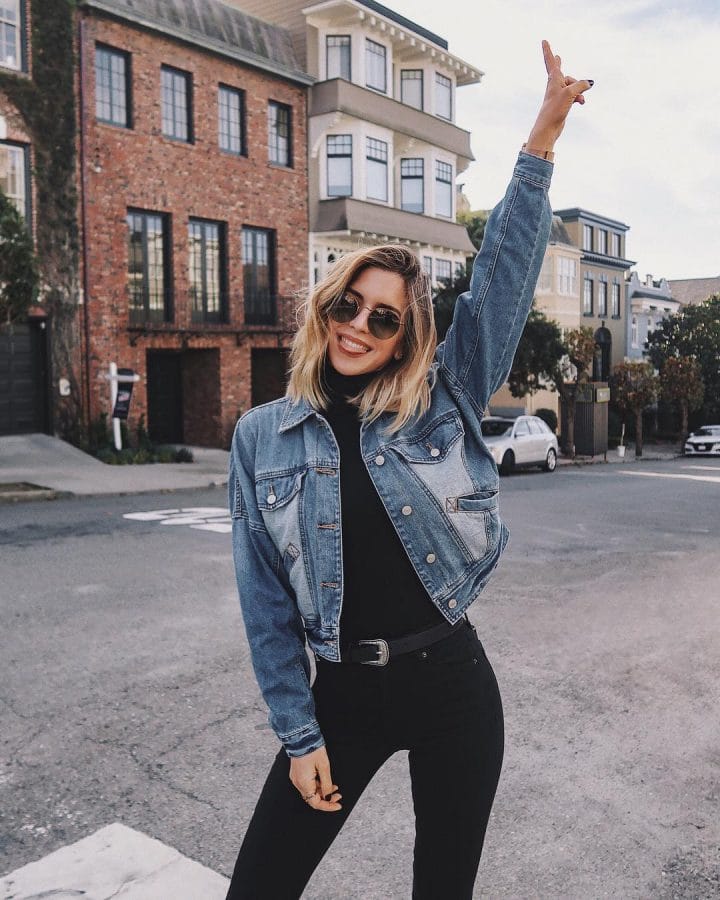 Styling a jean jacket with black turtleneck and black jeans.