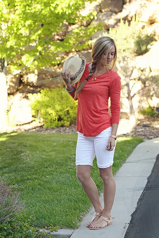 Outfit with 3/4 length red shirt, white bermuda shorts, and sandals.