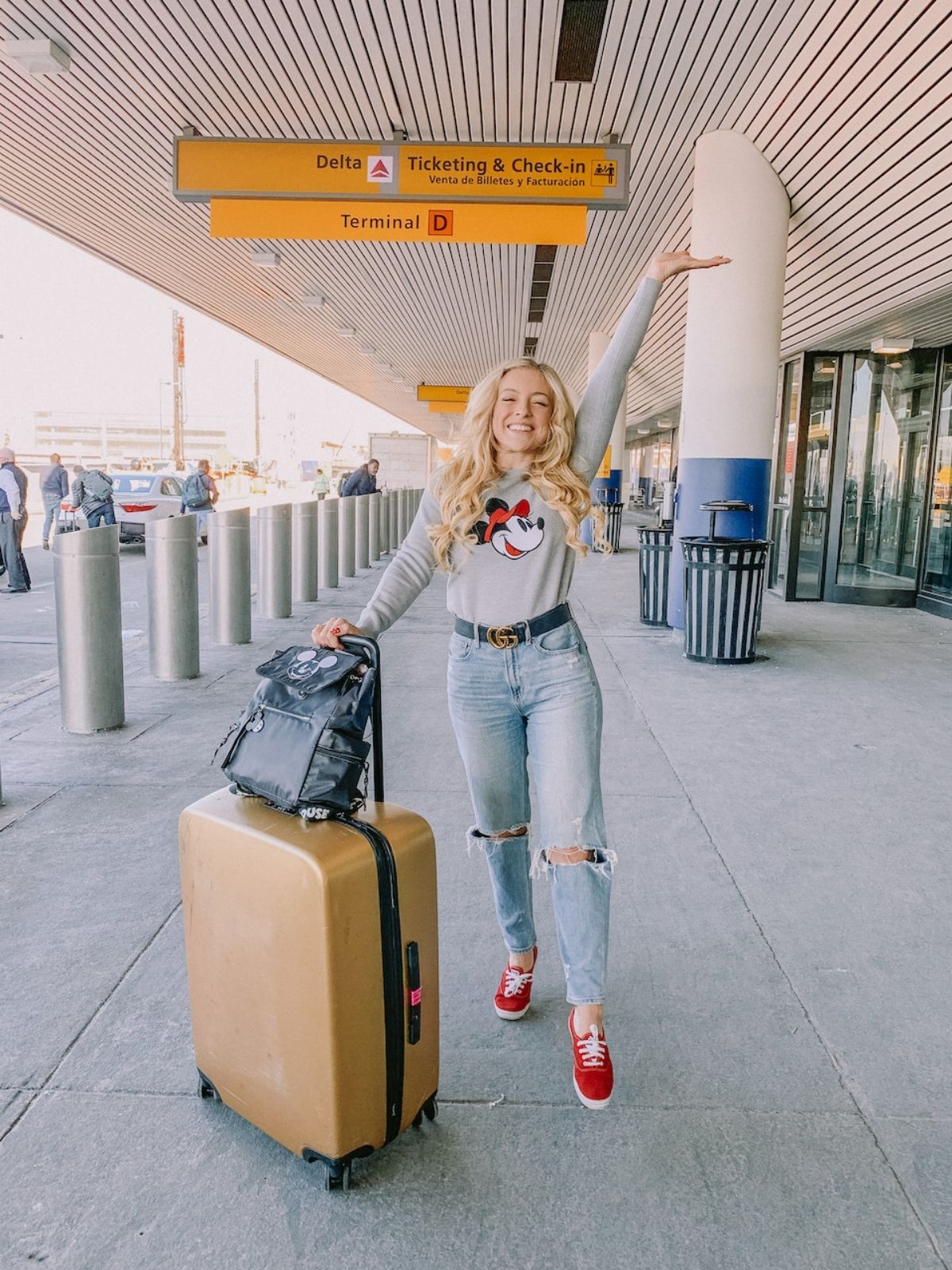 casual disney world outfit for winter featuring jeans and long sleeve shirt