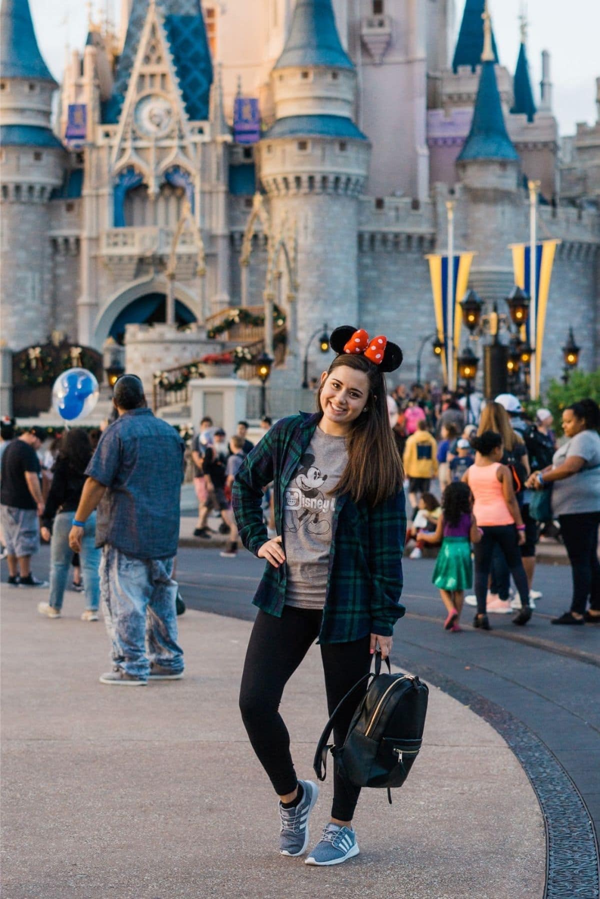 fall disney outfit with mickey ears, flannel shirt, and athletic shoes