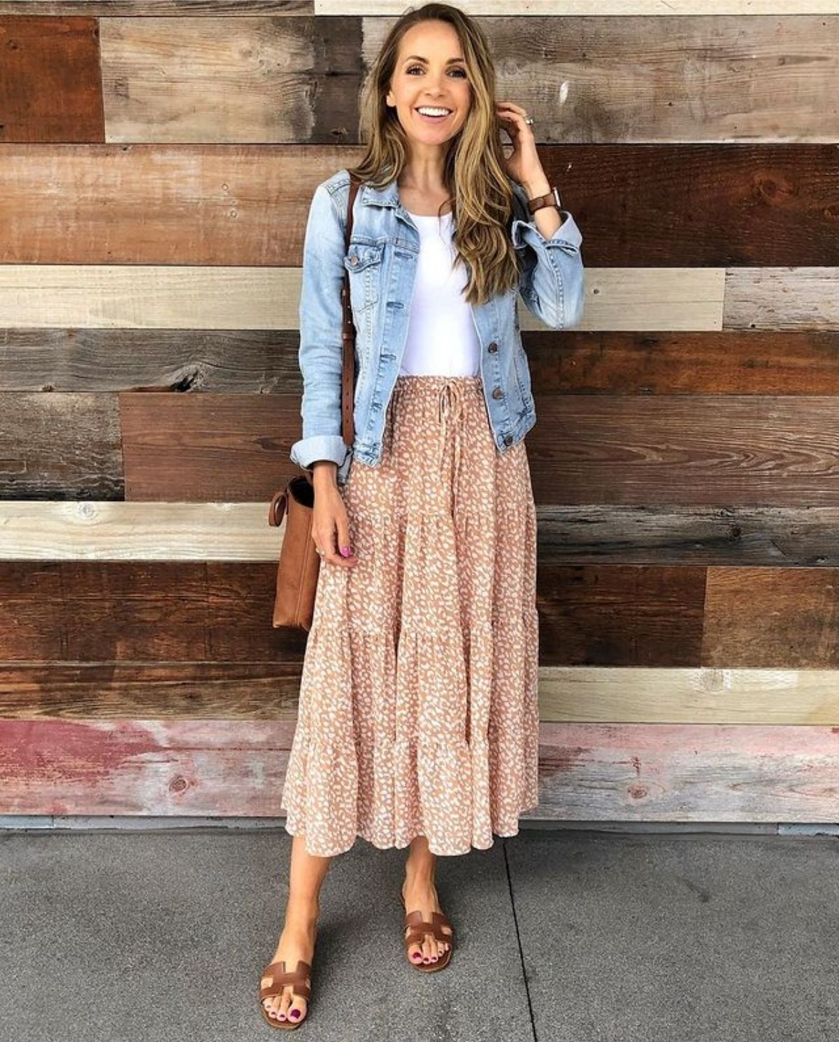 outfit with peach colored spring skirt, sandals, white top, and light denim jacket