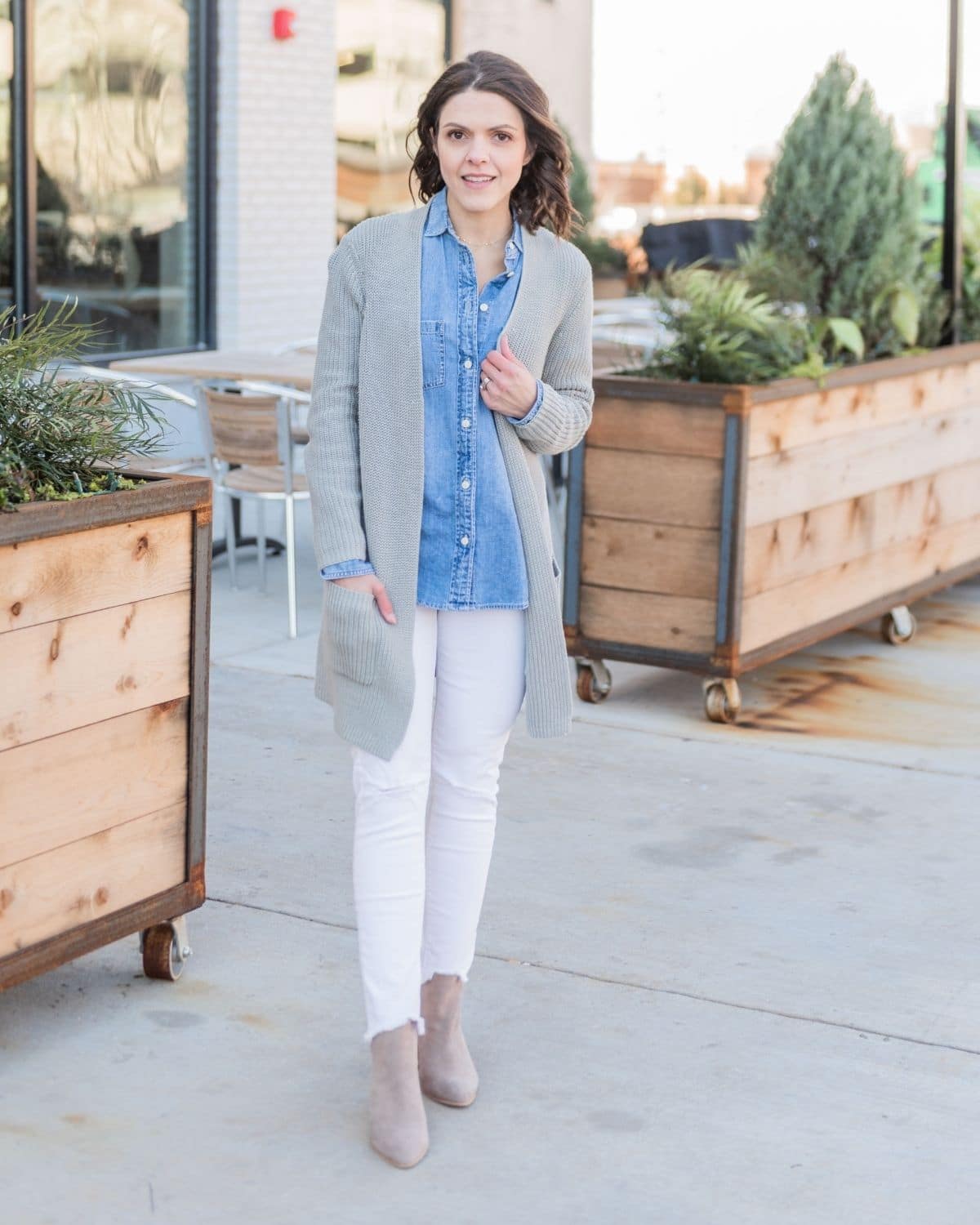 wear a chambray shirt under a gray oversized cardigan and white jeans