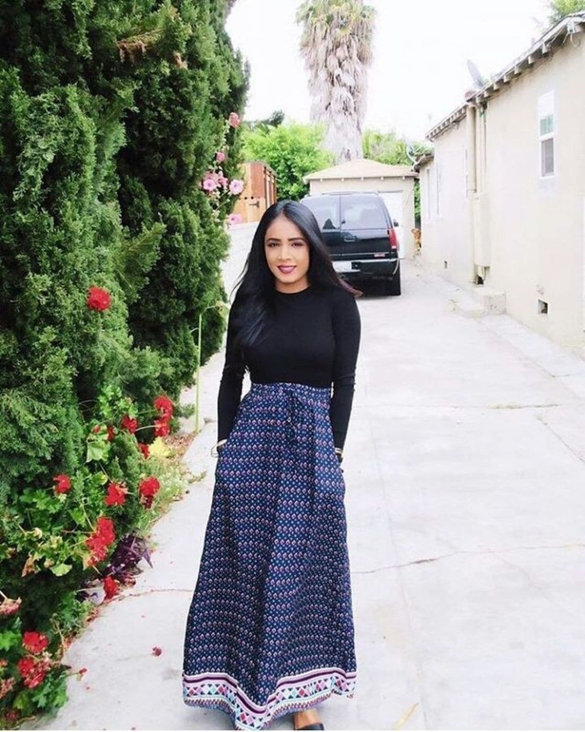 wearing printed long skirt with black long sleeve top