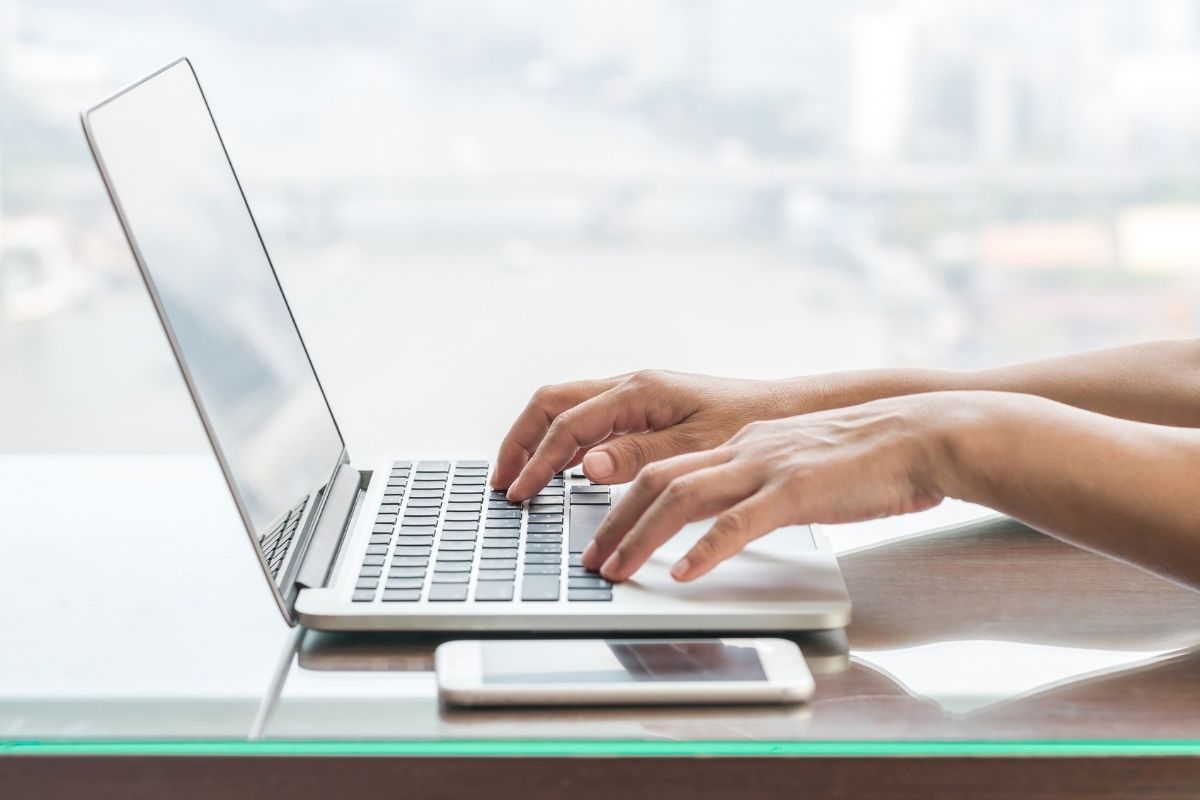 person typing on a laptop