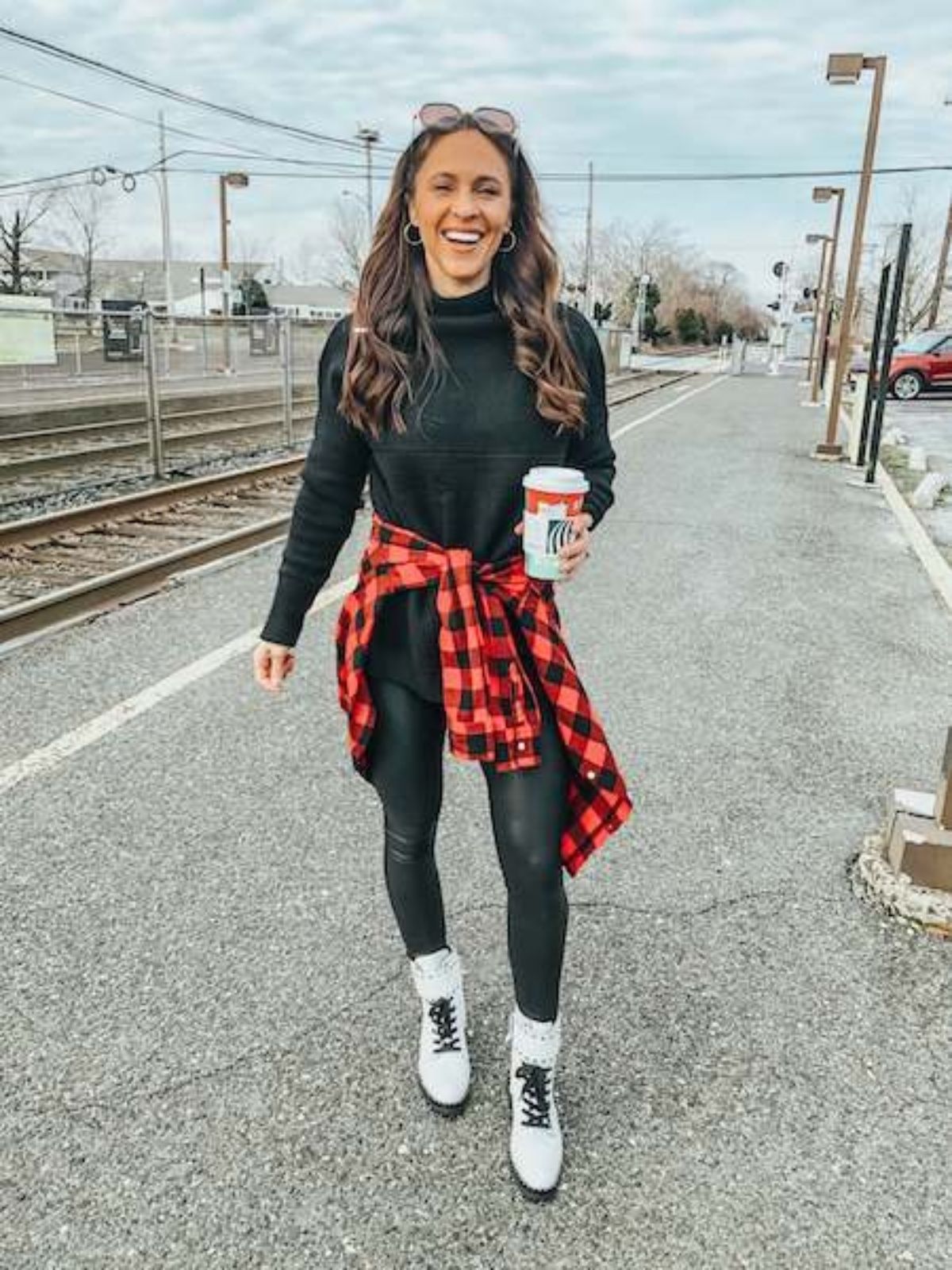 combat boots outfit with plaid shirt tied around her waist