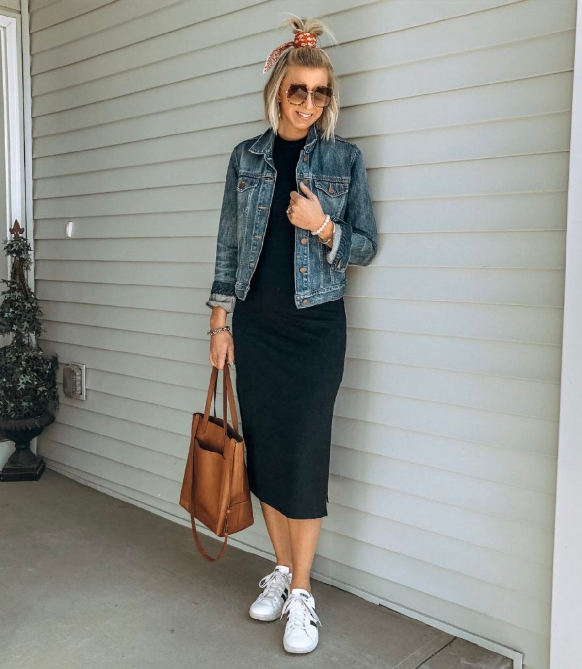 style a black dress with a jean jacket