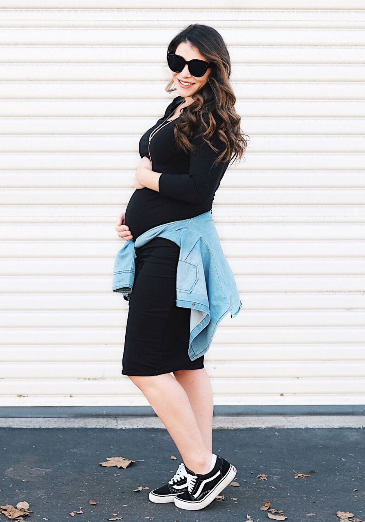 style a black dress by tying a shirt around your waist