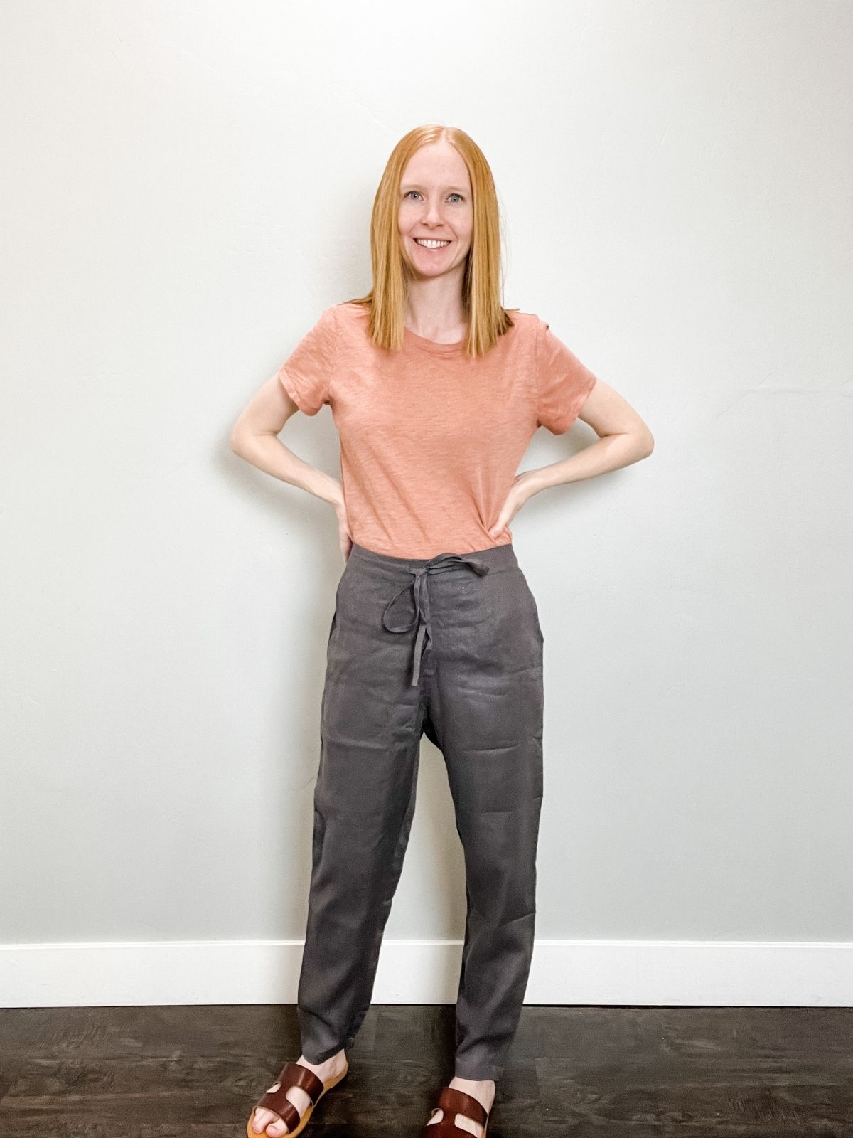 gray linen pants outfit with pink shirt and brown sandals