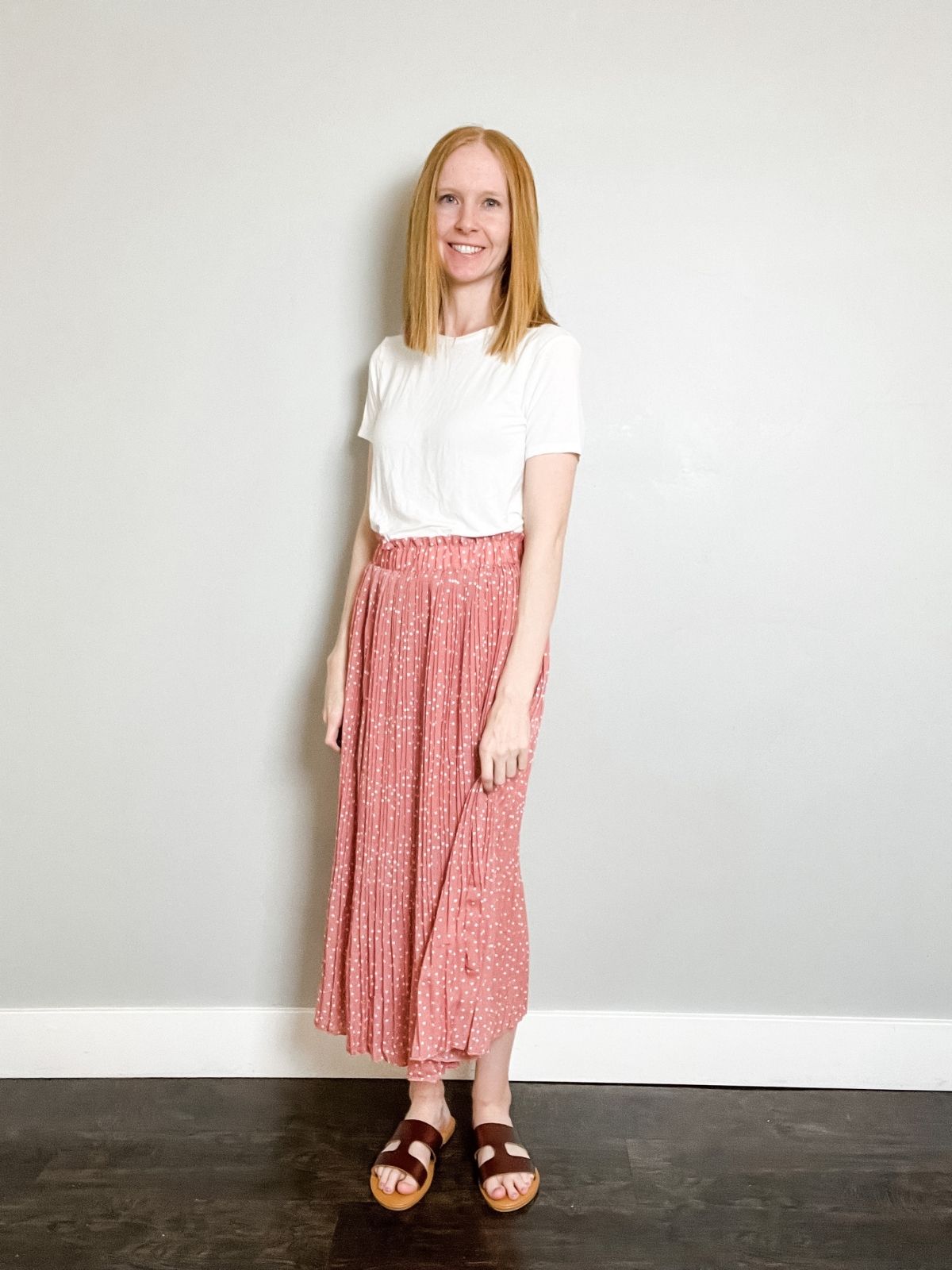 pink midi skirt outfit with white skirt and brown h sandals