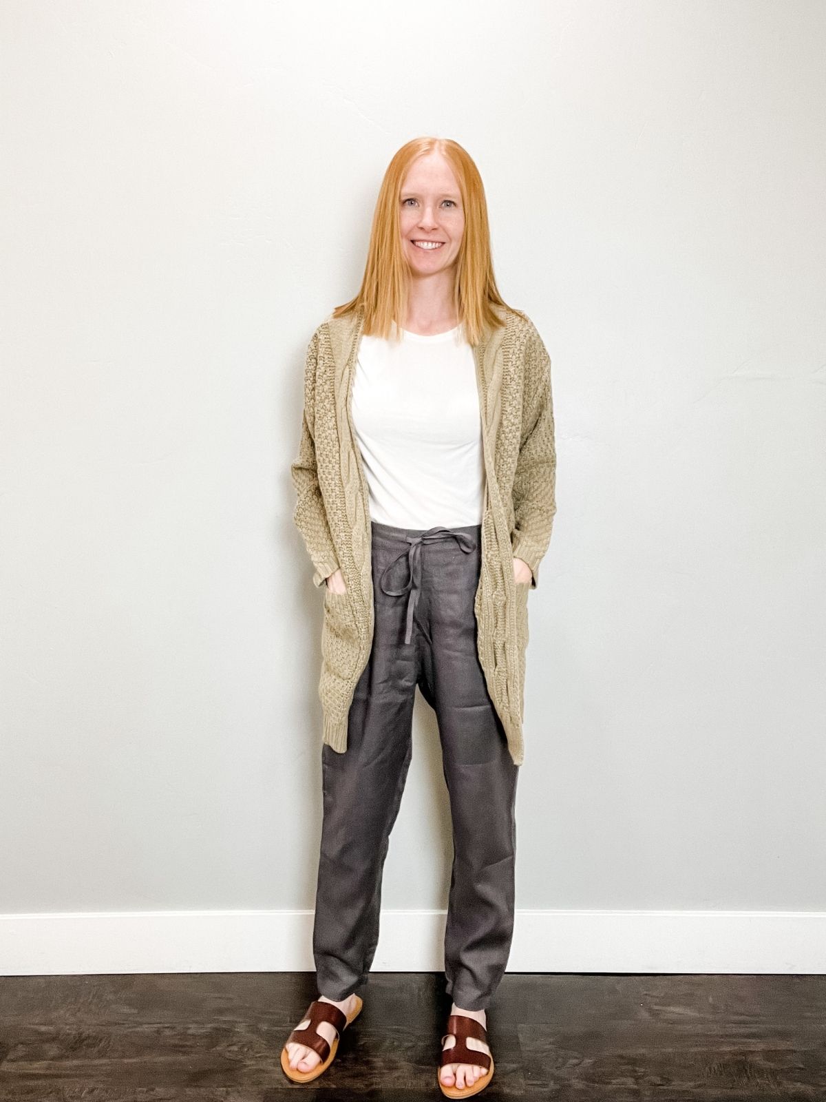 outfit with long cardigan, white shirt, gray linen pants, and sandals