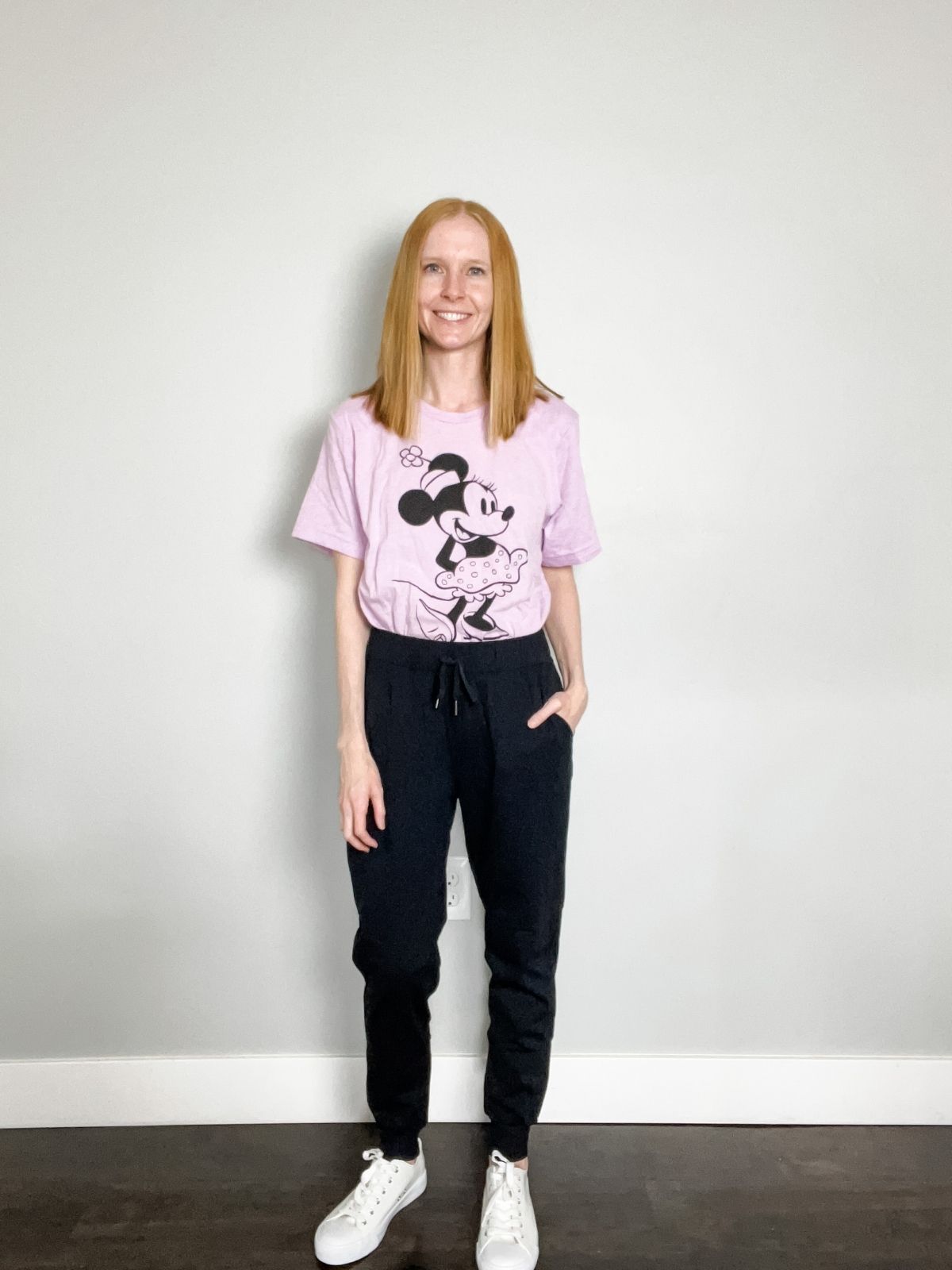 lilac vintage minnie mouse shirt with black joggers and white sneakers