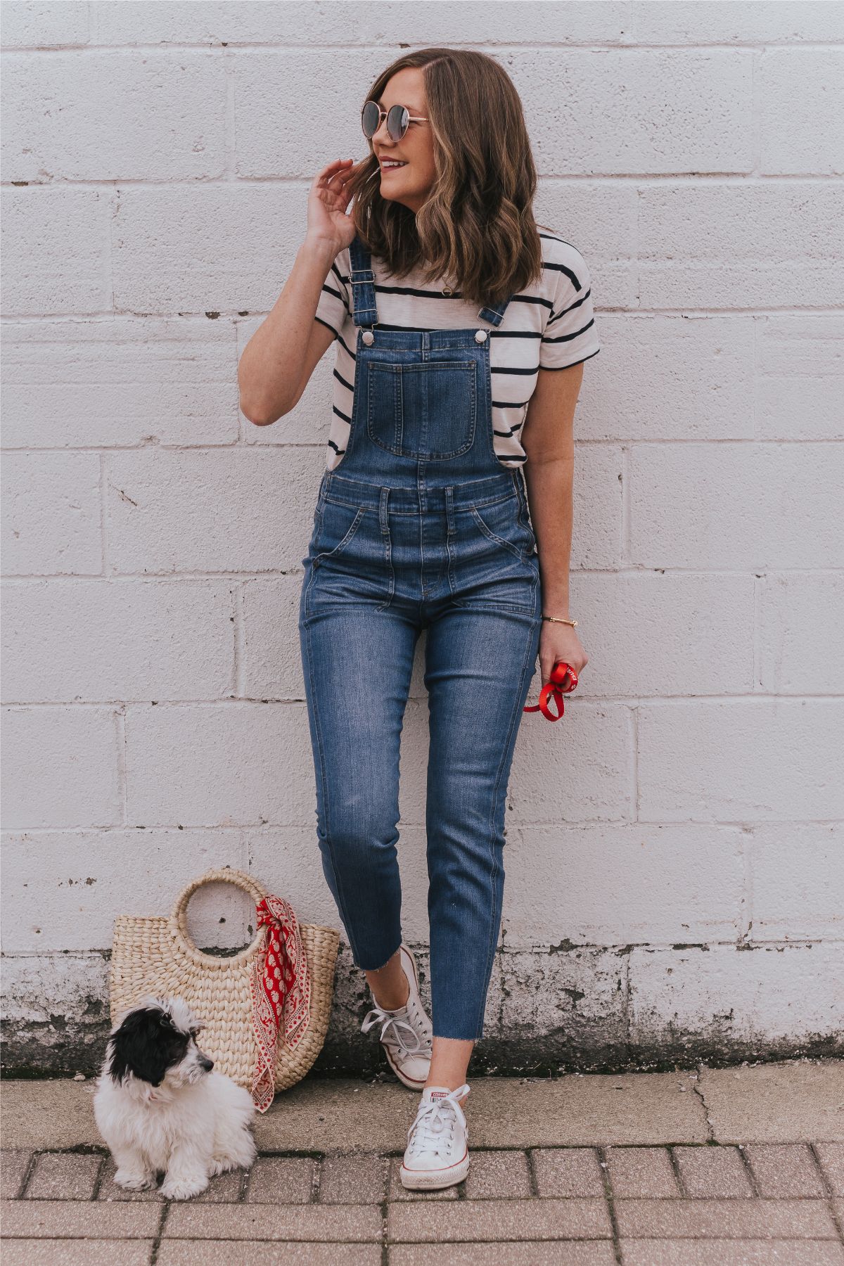 outfit with short sleeve shirt, denim overalls, and white converse sneakers