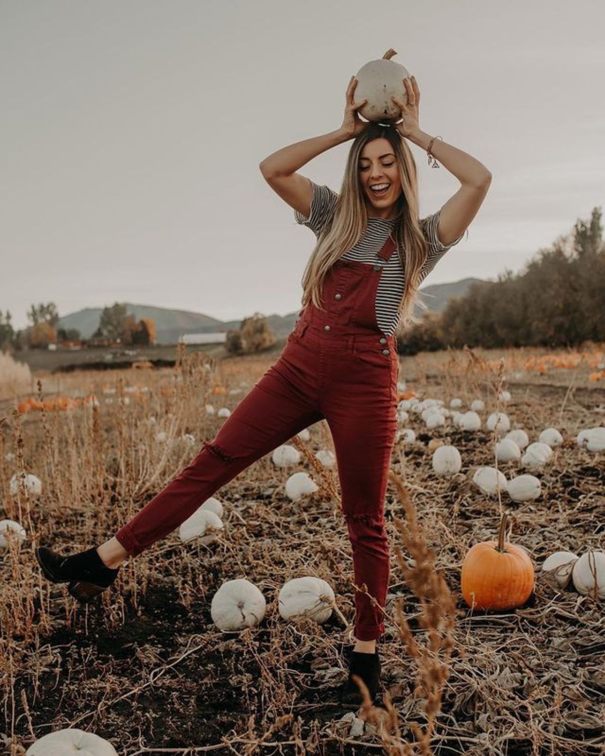 styling black booties with red overalls