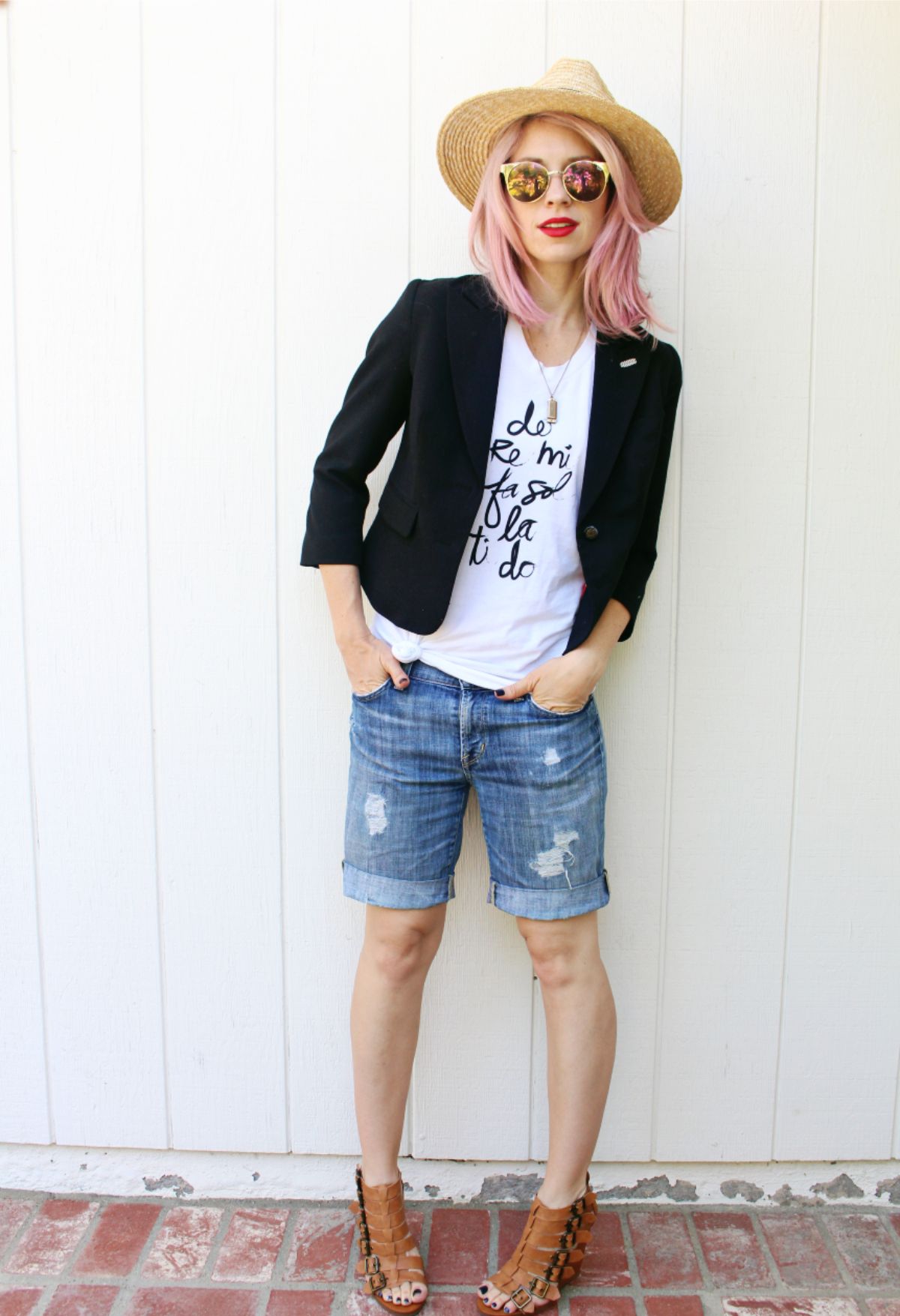 outfit with distressed bermuda shorts, graphic tee, and blazer.