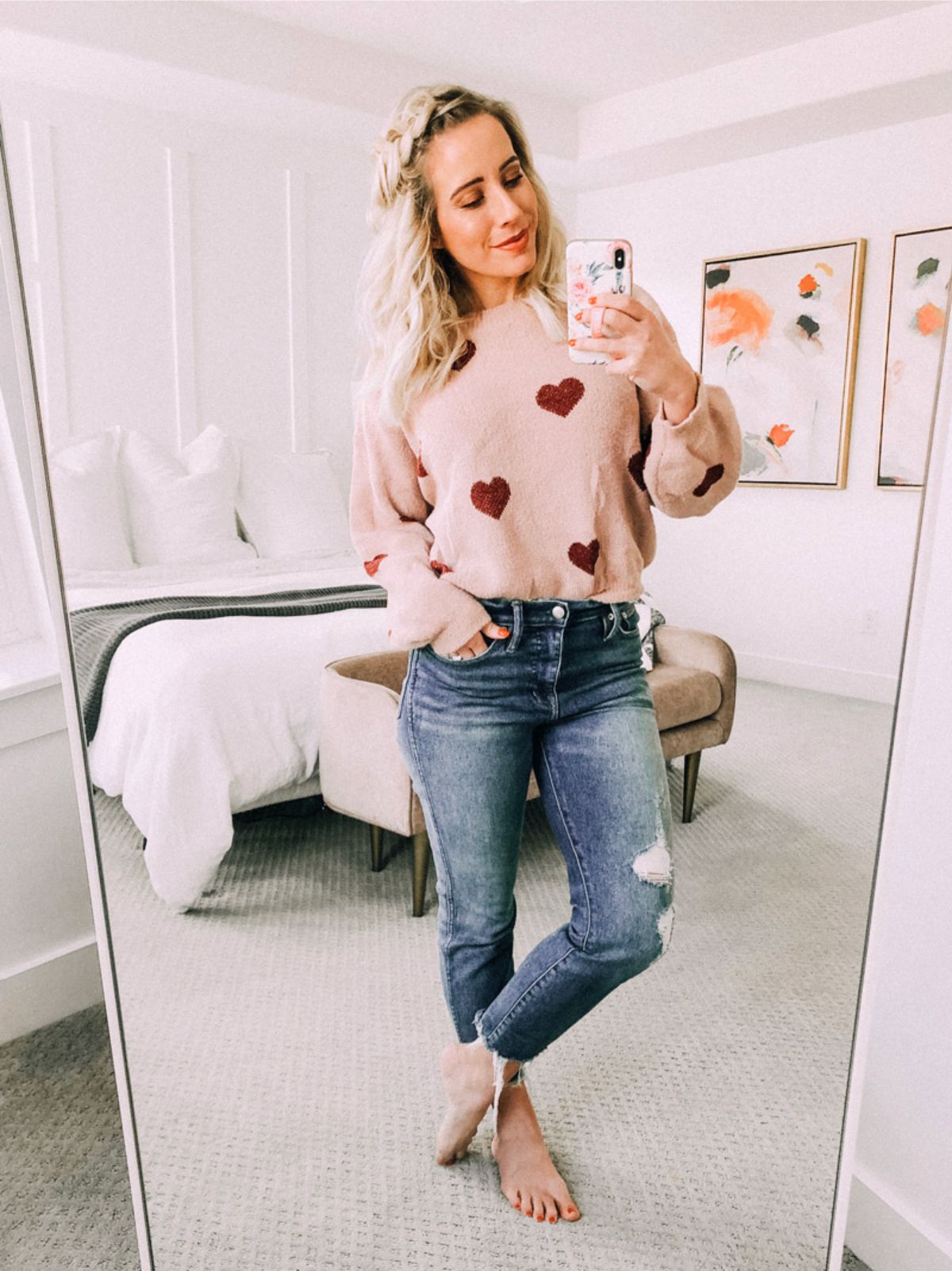 outfit with heart sweater and medium wash jeans