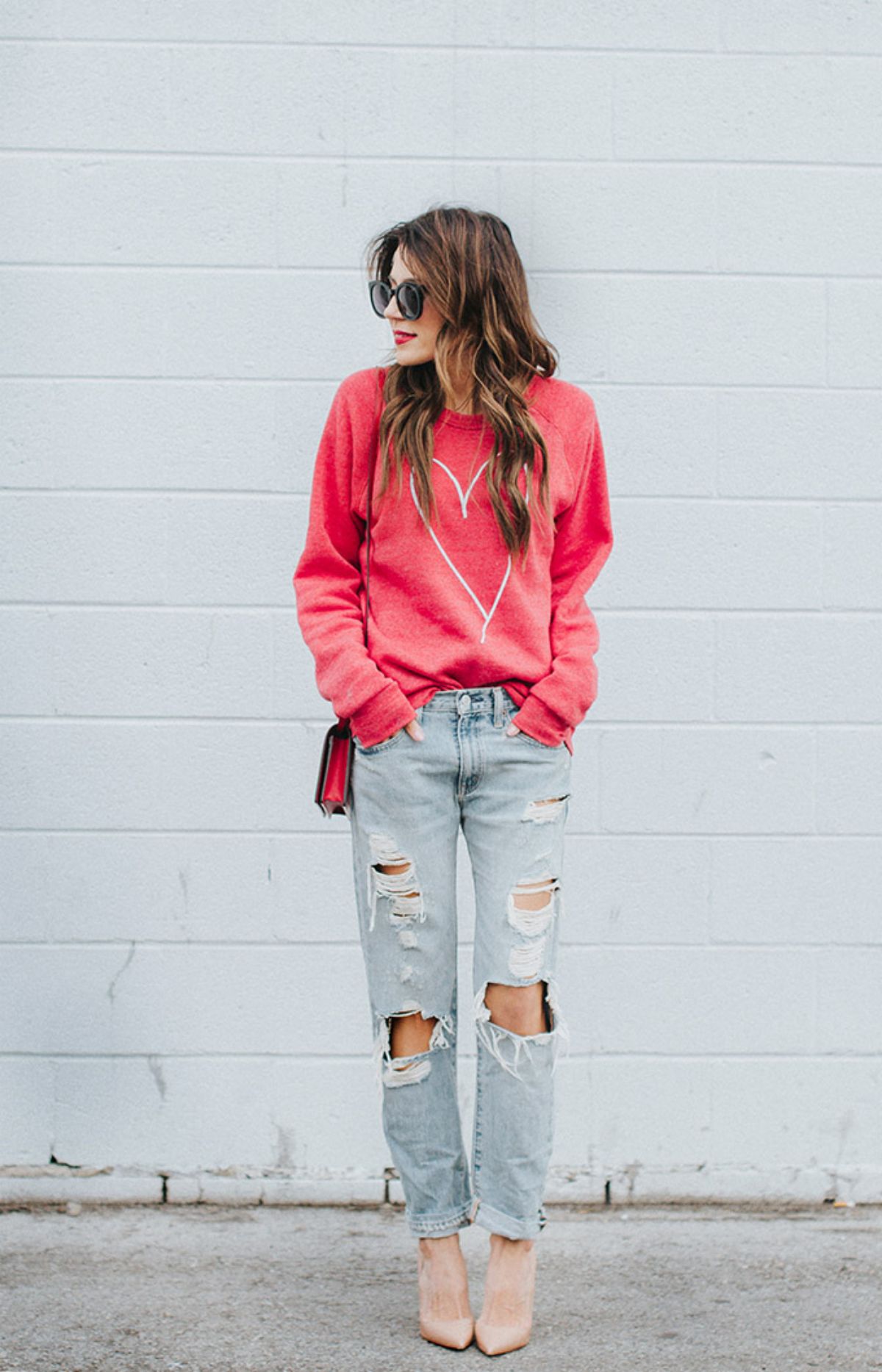 valentine's day outfit with red sweatshirt and loose distressed jeans