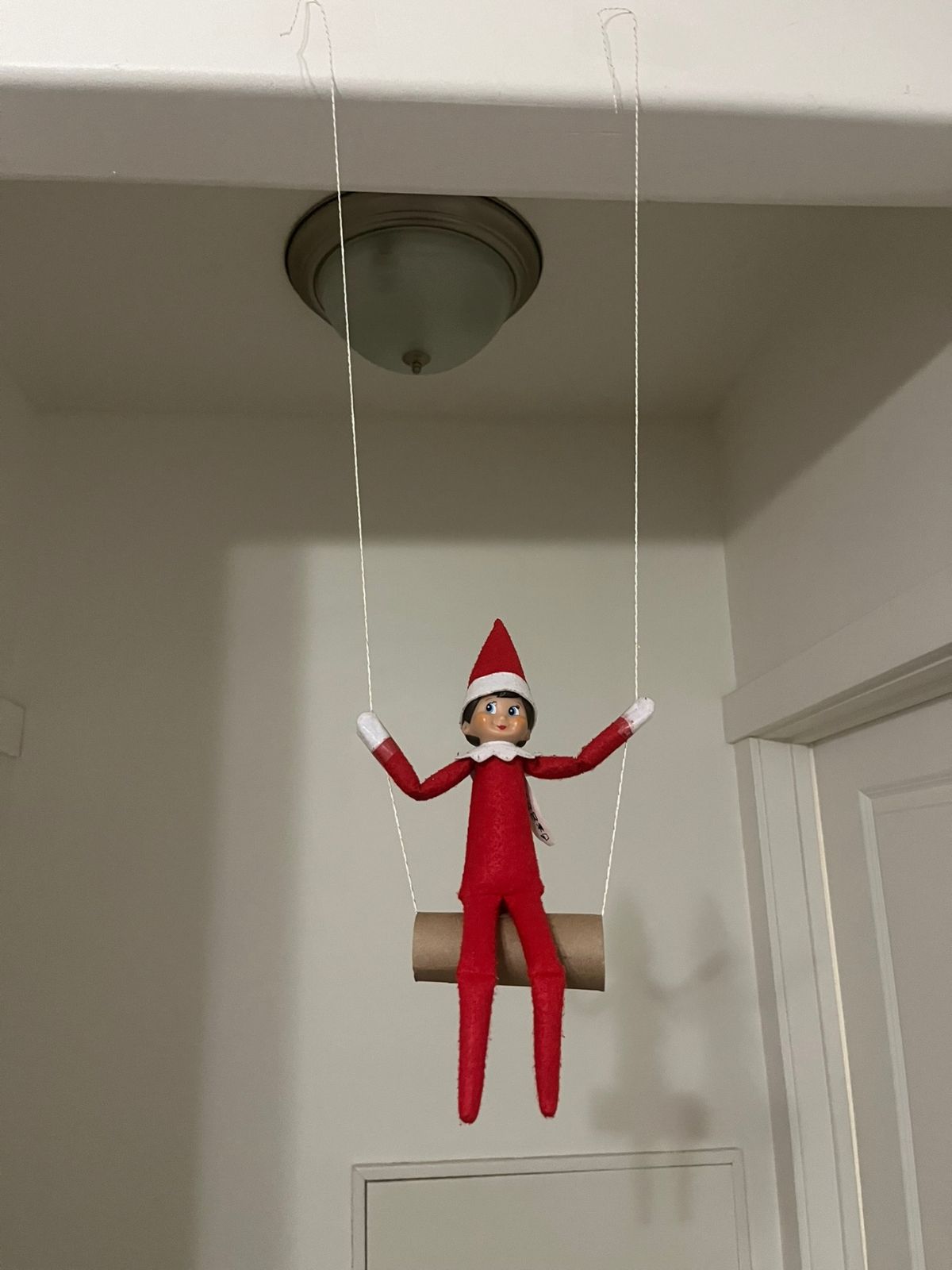 elf on the shelf on a swing