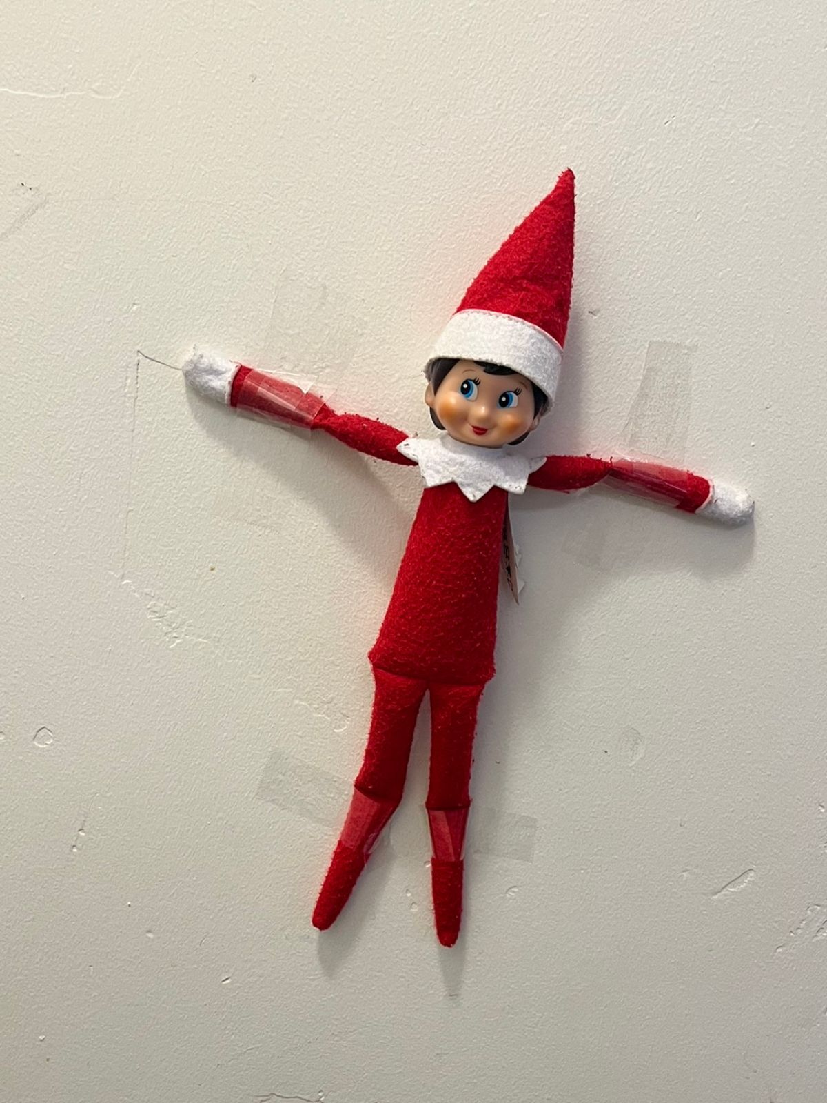 elf taped to the wall